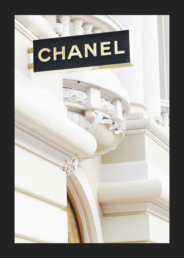 Photograph of Chanel sign against bright classic facade-12