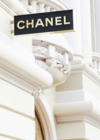 Photograph of Chanel sign against bright classic facade-7