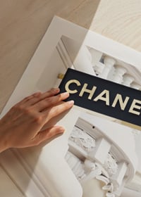 Photograph of Chanel sign against bright classic facade-9
