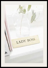 Photograph of gold-colored sign with the text LADY BOSS-2
