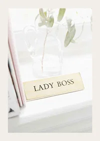 Photograph of gold-colored sign with the text LADY BOSS-3