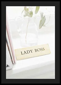 Photograph of gold-colored sign with the text LADY BOSS-4