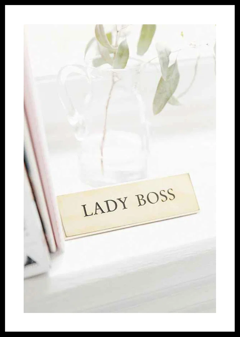 Photograph of gold-colored sign with the text LADY BOSS-12