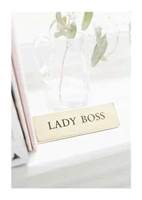 Photograph of gold-colored sign with the text LADY BOSS-1