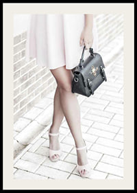 Photograph of woman in pink dress with black handbag-2