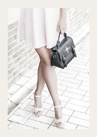 Photograph of woman in pink dress with black handbag-3