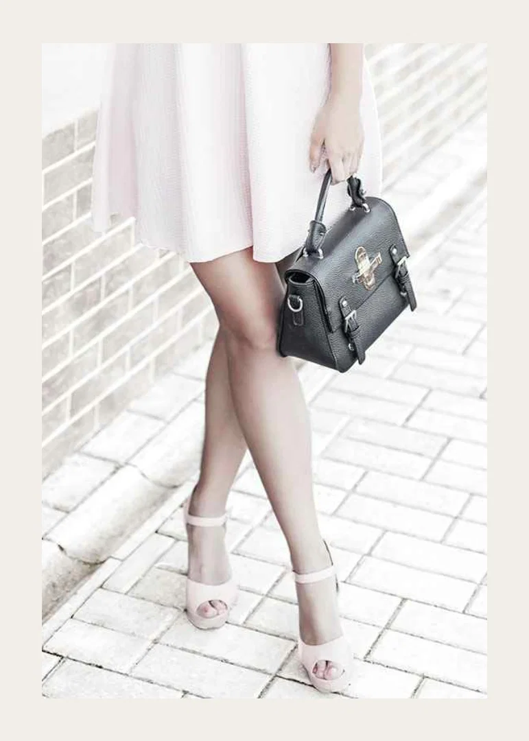 Photograph of woman in pink dress with black handbag-12