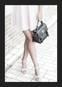 Photograph of woman in pink dress with black handbag-5