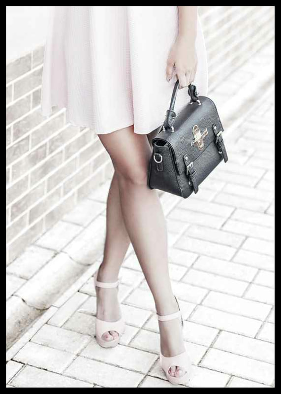 Photograph of woman in pink dress with black handbag-12
