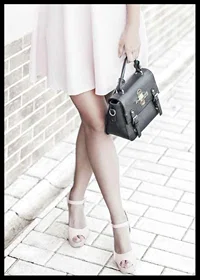Photograph of woman in pink dress with black handbag-6