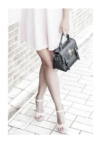 Photograph of woman in pink dress with black handbag-1