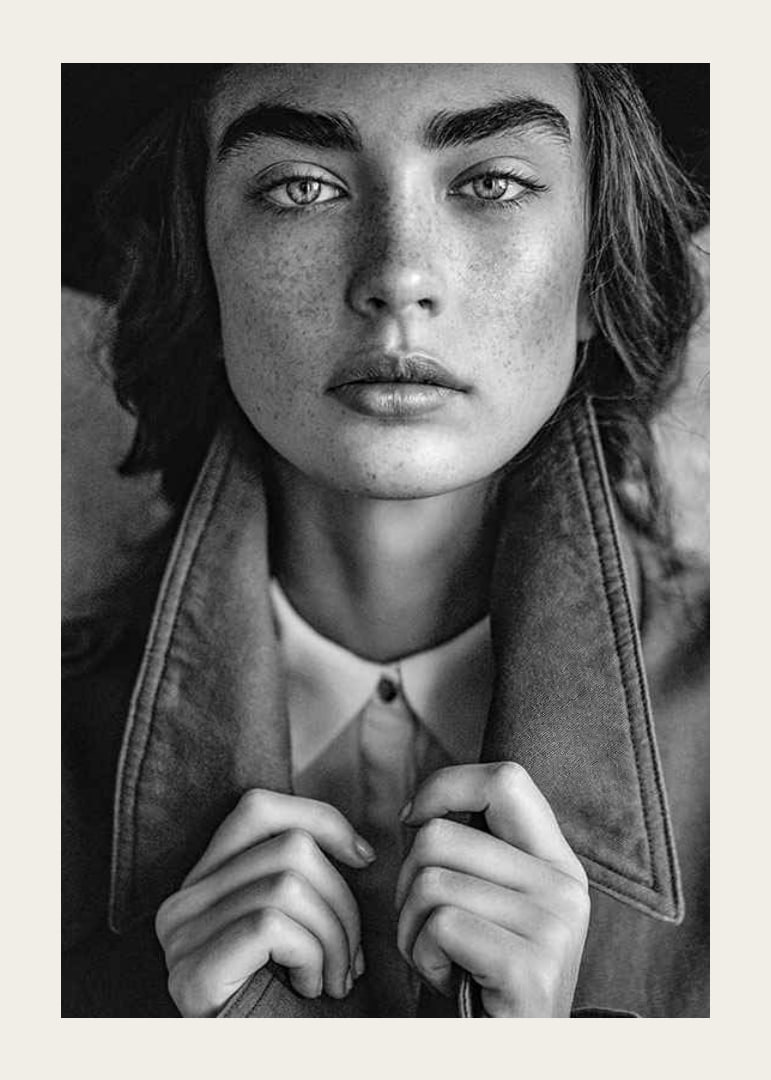 Black and white photograph of young woman with freckles and defined eyebrows-12