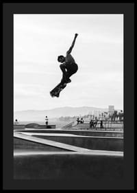 Mustavalkoinen valokuva skeittaajasta ilmassa skeittipuiston yllä-4