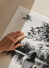Svartvit fotografi av kvinna i båt på stilla sjö med träd-9