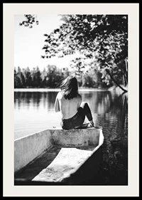 Black and white photograph of woman in boat on calm lake with trees-2