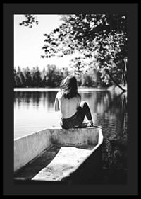 Svartvit fotografi av kvinna i båt på stilla sjö med träd-4