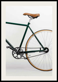 Photograph of green bicycle with brown saddle against light background-2