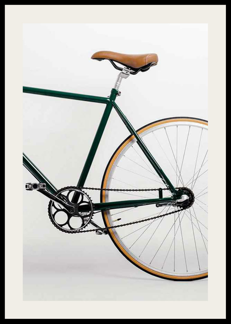Photograph of green bicycle with brown saddle against light background-12