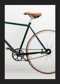 Photograph of green bicycle with brown saddle against light background-5