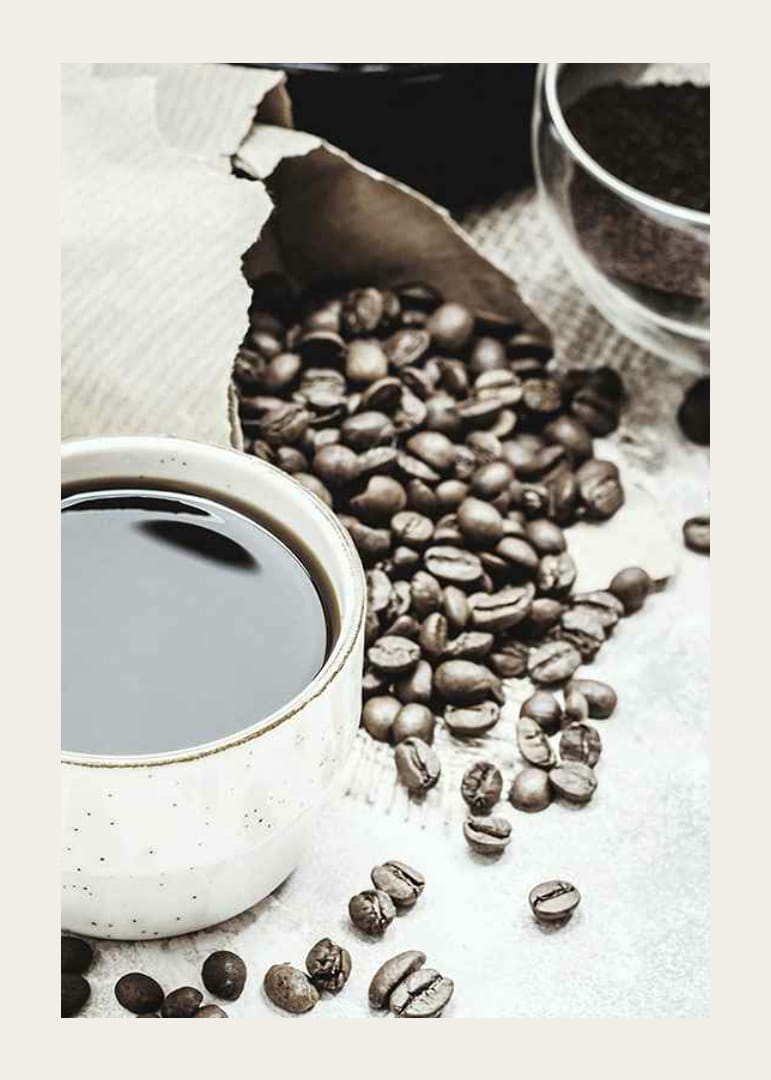 Photographic close-up of coffee cup and coffee beans in warm tones-12