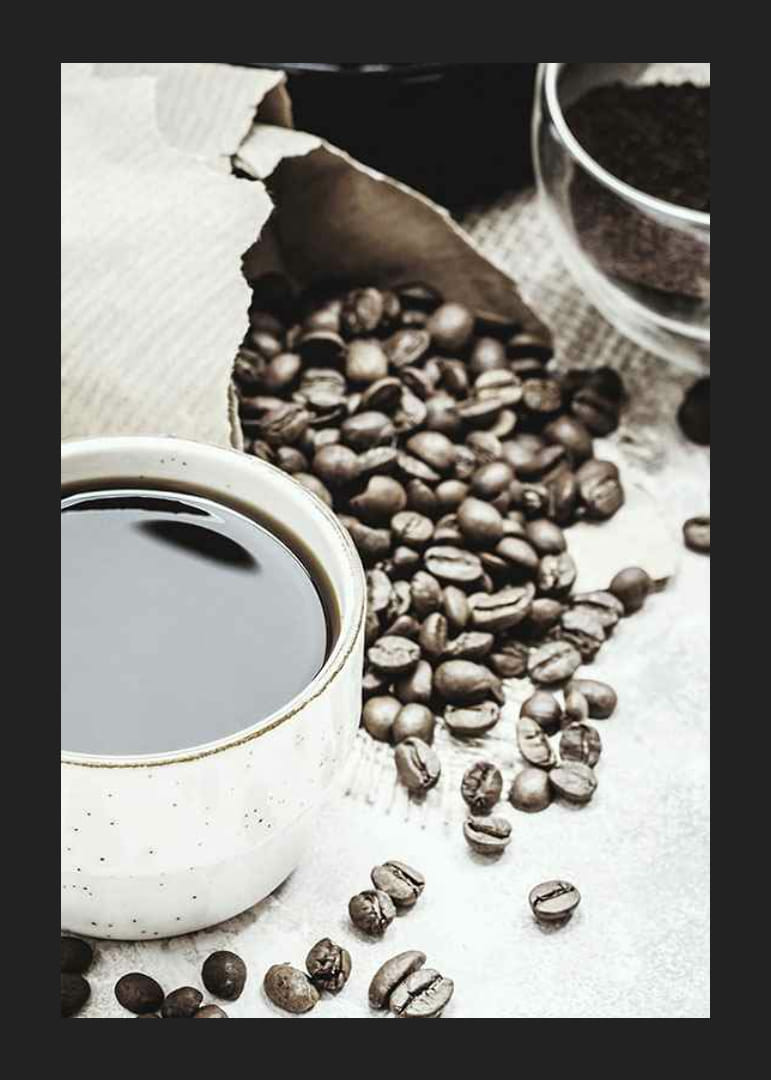 Photographic close-up of coffee cup and coffee beans in warm tones-12