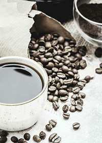 Photographic close-up of coffee cup and coffee beans in warm tones-7