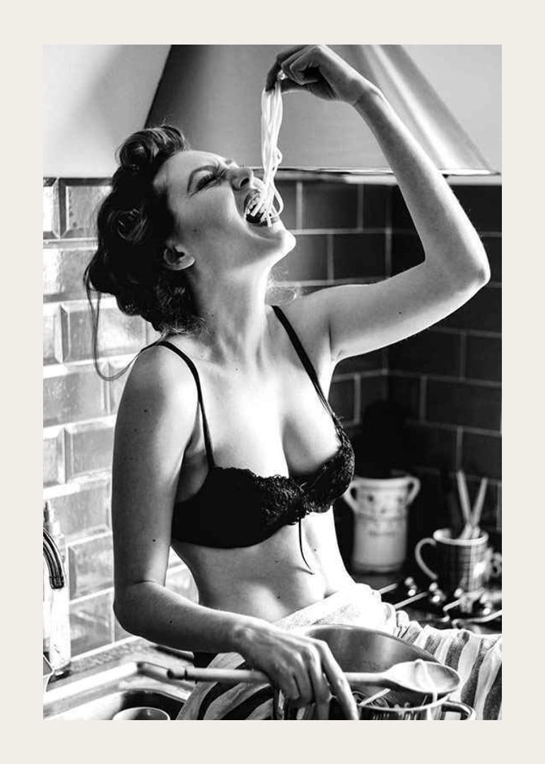 Black and white photo art with woman eating spaghetti in kitchen-12