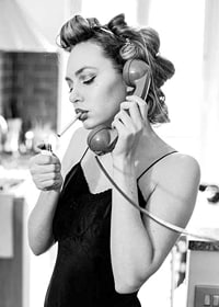 Black and white photo of woman with hair curlers, phone and cigarette-7