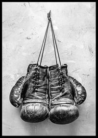 Black and white worn boxing gloves against rough wall-6