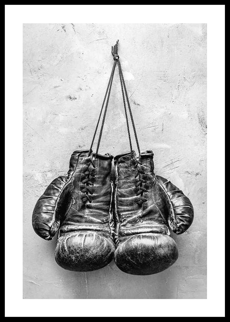 Black and white worn boxing gloves against rough wall-12