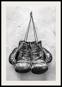 Black and white worn boxing gloves against rough wall-2