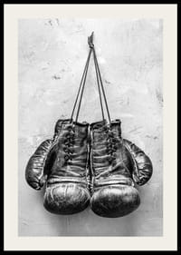 Black and white worn boxing gloves against rough wall-2