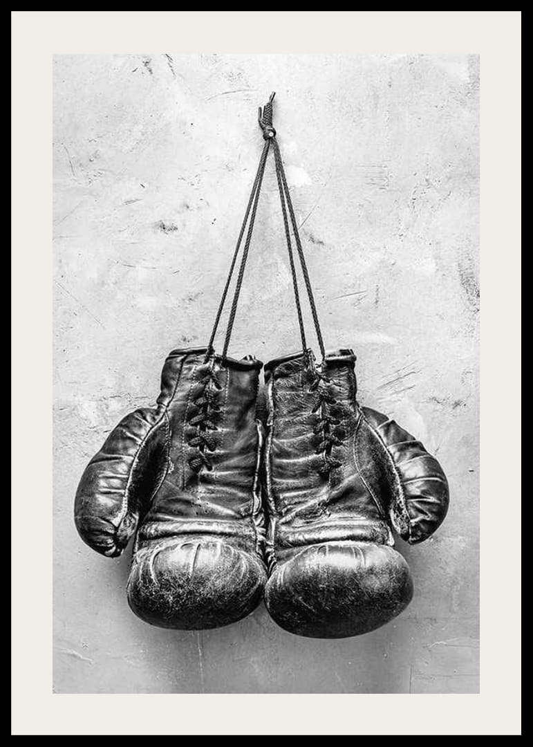 Black and white worn boxing gloves against rough wall-12