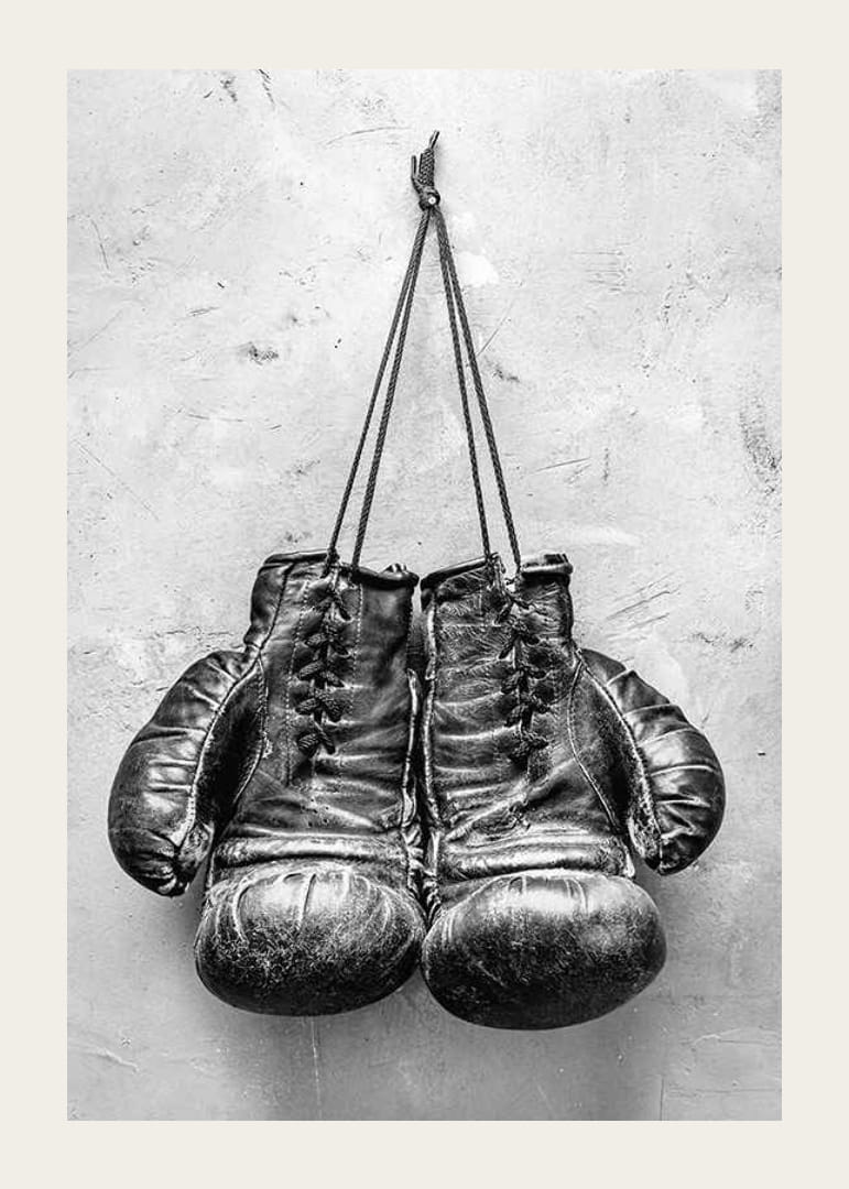 Black and white worn boxing gloves against rough wall-12