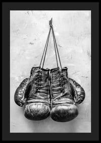Black and white worn boxing gloves against rough wall-4