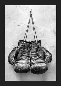 Black and white worn boxing gloves against rough wall-5