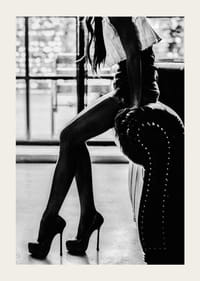 Čiernobiela módna fotografia ženy na vysokých podpätkoch pri kresle-3