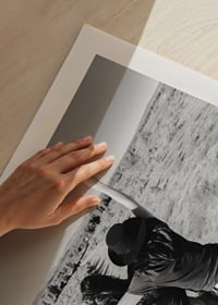 Black and white photograph of two girls on car hood in front of open nature-9