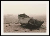 Photograph of old wooden boat on rocky beach in fog-2