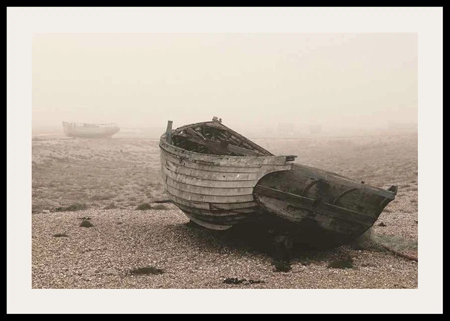 Photograph of old wooden boat on rocky beach in fog-12