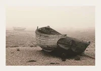 Photograph of old wooden boat on rocky beach in fog-3