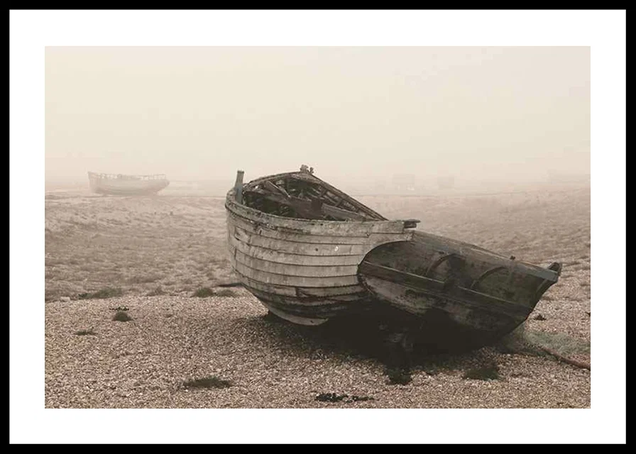 Photograph of old wooden boat on rocky beach in fog-12