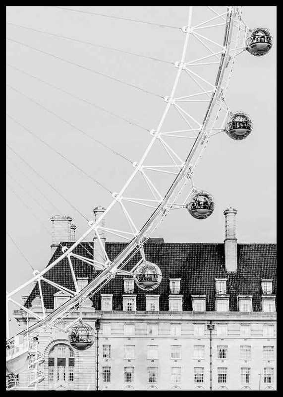 Black and white photo of London Eye against classic building-12