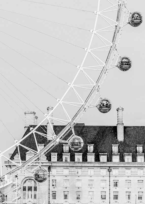 Black and white photo of London Eye against classic building-12