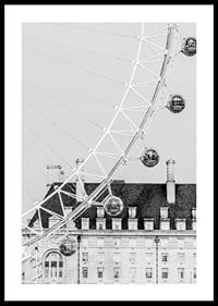 Black and white photo of London Eye against classic building-0