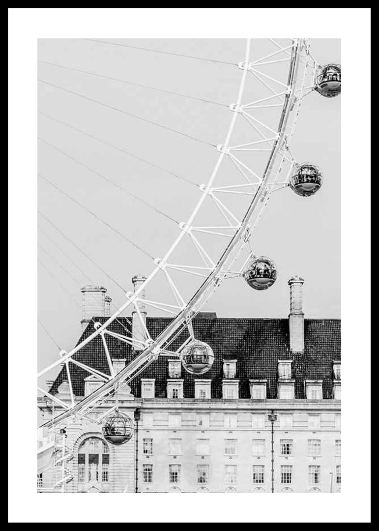 Black and white photo of London Eye against classic building-12