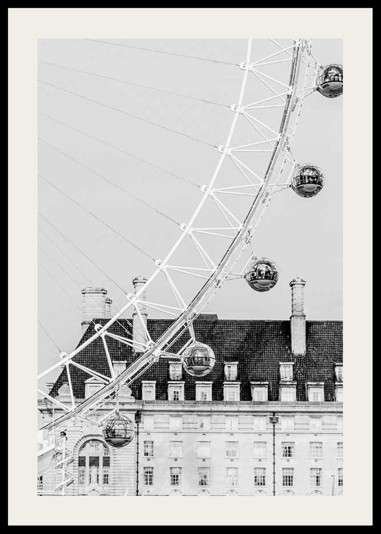 Black and white photo of London Eye against classic building-12