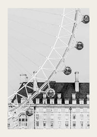 Black and white photo of London Eye against classic building-3