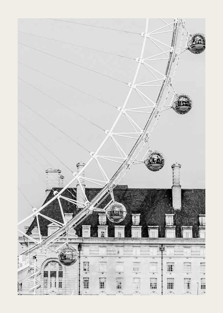 Black and white photo of London Eye against classic building-12