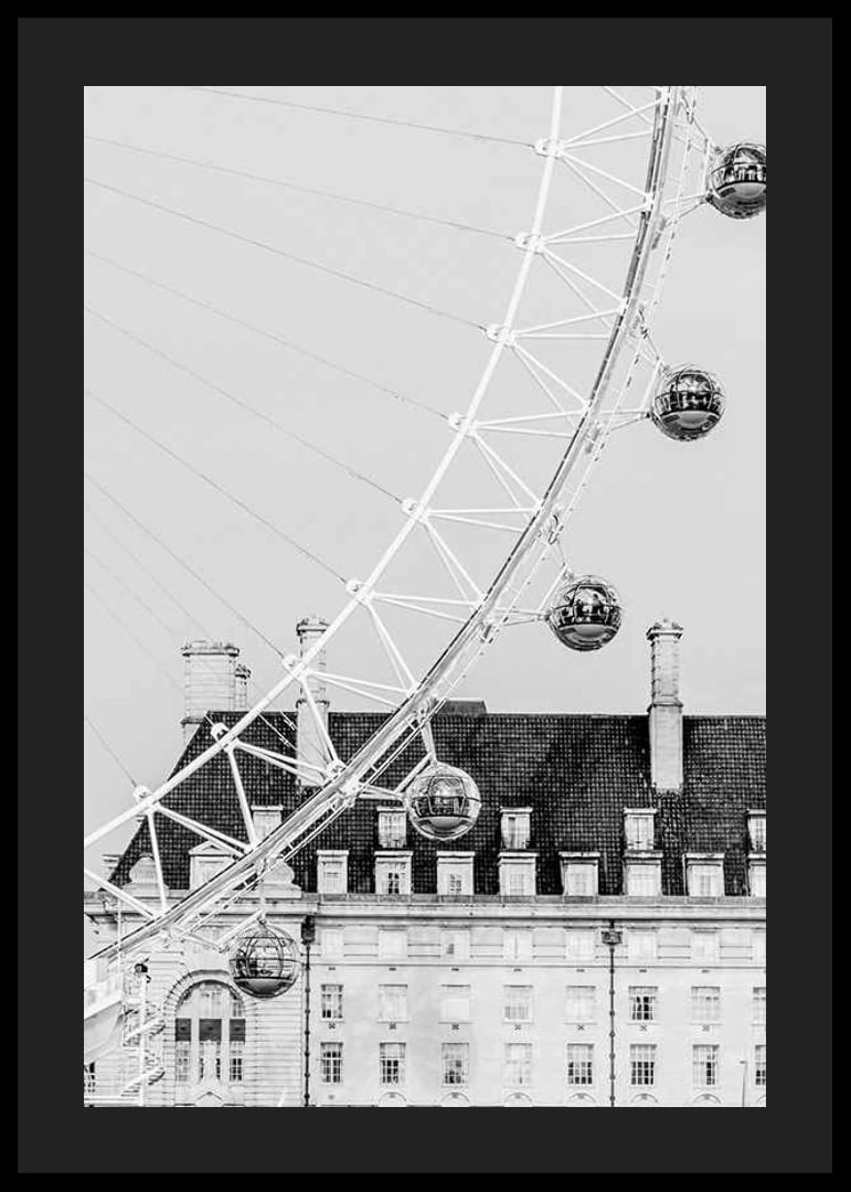Black and white photo of London Eye against classic building-12